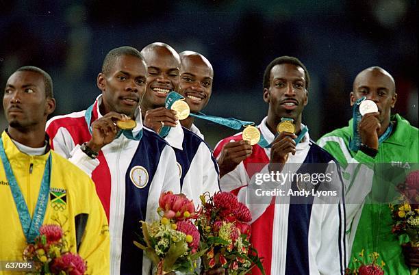 Michael Johnson of the USA poses with teammates Antonio Pettigrew, Alvin And Calvin Harrison as they receive their Gold Medal in the Mens 4x400m...