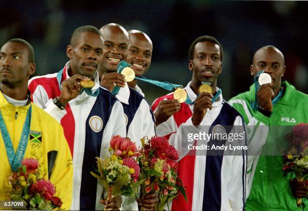 Michael Johnson of the USA poses with teammates Antonio Pettigrew, Alvin And Calvin Harrison as they receive their Gold Medal in the Mens 4x400m...