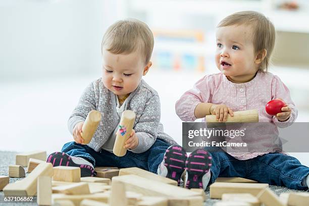 twins babies playing happily - baby blocks stock pictures, royalty-free photos & images