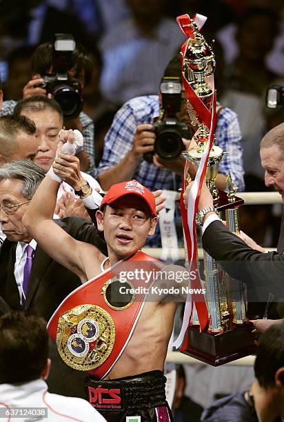 Japan - IBF Mini Flyweight champion Katsunari Takayama of Japan celebrates after beating compatriot Shin Ono with a unanimous decision in their...