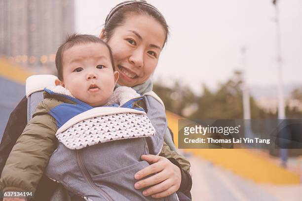 7 months old baby outing with mom - my lai sit stock pictures, royalty-free photos & images