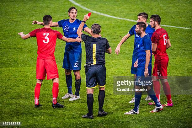 referee holds up red card - red card stock pictures, royalty-free photos & images