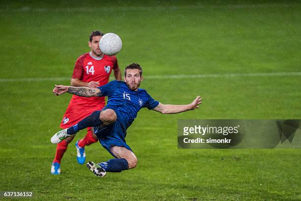 football players playing football - football player stock pictures, royalty-free photos & images
