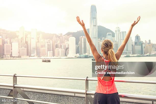beautiful and sporty young woman stretching after jogging - kowloon stock pictures, royalty-free photos & images