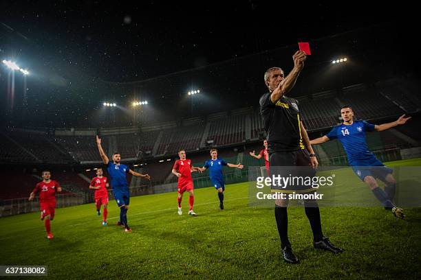 referee holds up red card - red card stock pictures, royalty-free photos & images