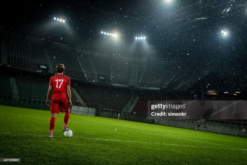 Football player standing in stadium