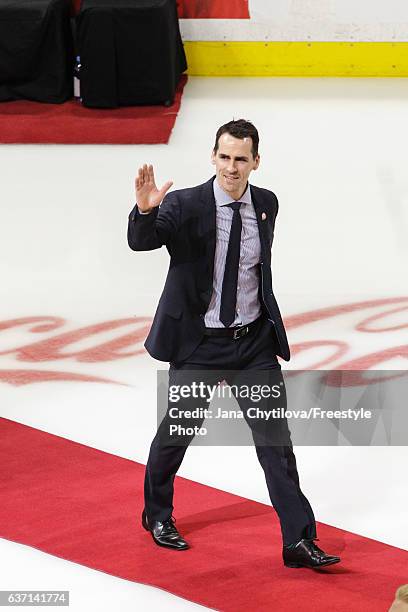 Former Ottawa Senators Wade Redden waves to the fans during the jersey retirement ceremony for Daniel Alfredsson prior to a game against the Detroit...