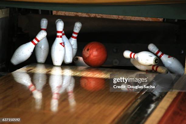 close up of bowling ball hitting the pins at a bowling alley - ten pin bowling foto e immagini stock