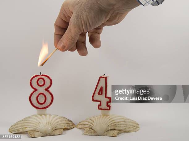 birthday candle number 84 - leuchtgeschoss stock-fotos und bilder