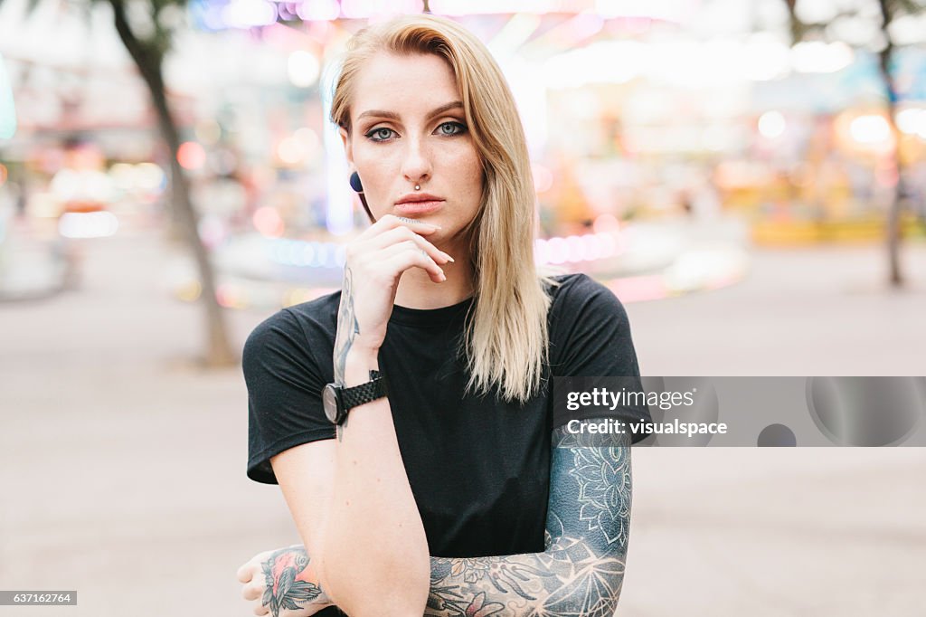 Portrait of a Tattooed Woman in an Amusement Park