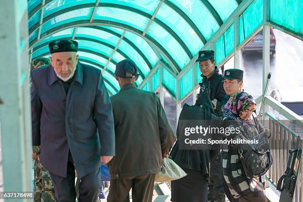 military patrol at bus station, urumqi,xinjiang, china - xinjiang 個照片及圖片檔