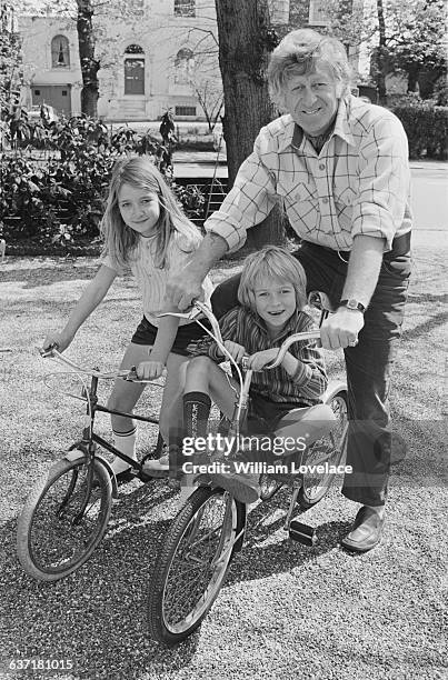 English actor Jon Pertwee and his son Sean and daughter Dariel cycling near their home in Barnes, London, UK, 2nd May 1971.