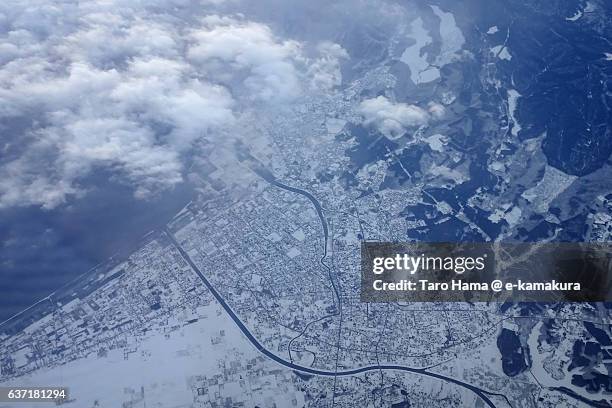 snow-covered mutsu city, aomori in winter from airplane - mutsu ストックフォトと画像