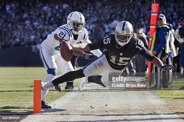 Wide receiver Michael Crabtree of the Oakland Raiders dives with a catch to the two yard line for 15 yards to set up a touchdown against cornerback...