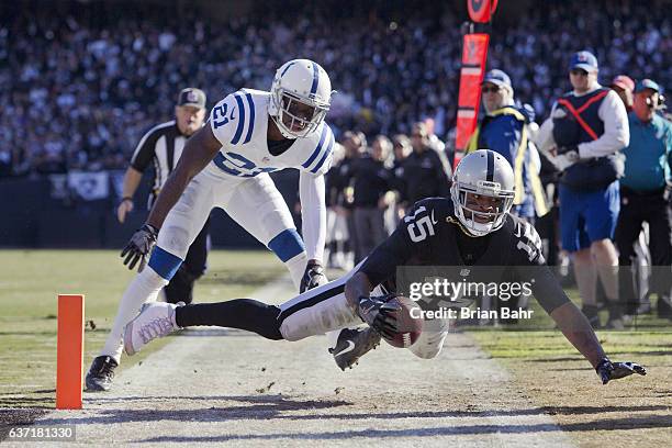 Wide receiver Michael Crabtree of the Oakland Raiders dives with a catch to the two yard line for 15 yards to set up a touchdown against cornerback...