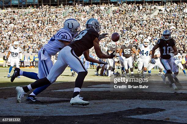 Wide receiver Andre Holmes of the Oakland Raiders scores a touchdown on a catch against cornerback Rashaan Melvin of the Indianapolis Colts in the...