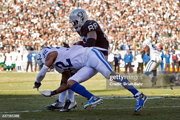 Tight end Clive Walford of the Oakland Raiders scores on a five yard touchdown against safety T.J. Green of the Indianapolis Colts in the second...