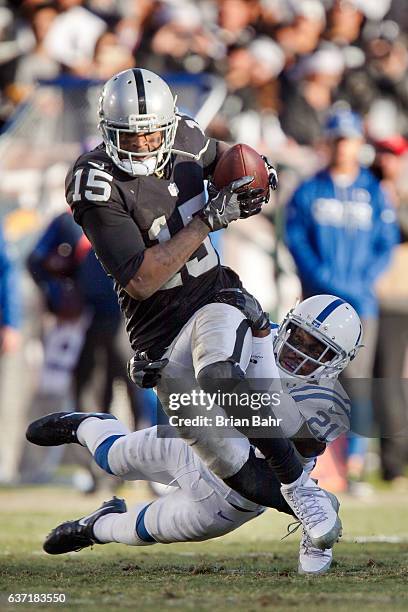 Wide receiver Michael Crabtree of the Oakland Raiders gets eight yards on a catch against cornerback Vontae Davis of the Indianapolis Colts in the...