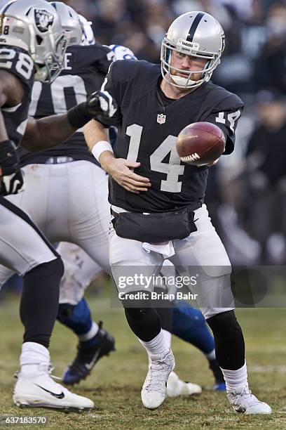 Quarterback Matt McGloin of the Oakland Raiders hands off the ball to running back Latavius Murray of the Oakland Raiders against the Indianapolis...