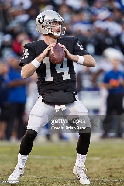 Quarterback Matt McGloin of the Oakland Raiders looks to throw to Amari Cooper late in the fourth quarter against the Indianapolis Colts on December...