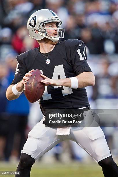 Quarterback Matt McGloin of the Oakland Raiders looks to throw to Amari Cooper late in the fourth quarter against the Indianapolis Colts on December...