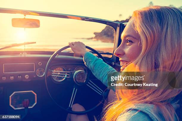 woman driving a convertible at the beach. - road trip new south wales stock pictures, royalty-free photos & images