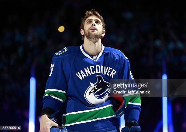 Brandon Sutter of the Vancouver Canucks listens to the national anthems during their NHL game against the Columbus Blue Jackets at Rogers Arena...