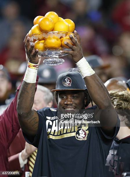 Dalvin Cook of the Florida State Seminoles celebrates winning the MVP award after the game against the Michigan Wolverines at the 2016 Capital One...