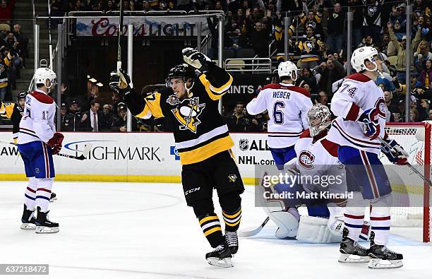 Sidney Crosby of the Pittsburgh Penguins celebrates an overtime goal scored by Evgeni Malkin against the Montreal Canadiens at PPG PAINTS Arena on...