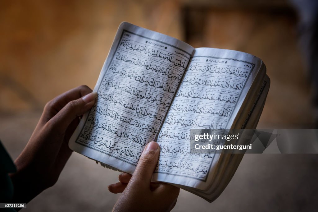 Female hands holding a koran book