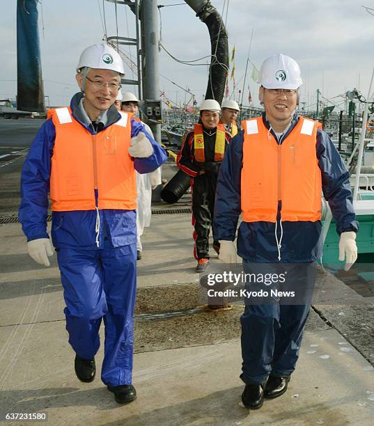 Higashidori, Japan - Japan's Nuclear Regulation Authority Commissioner Kunihiko Shimazaki heads to board a fishing boat in Higashidori, Aomori...