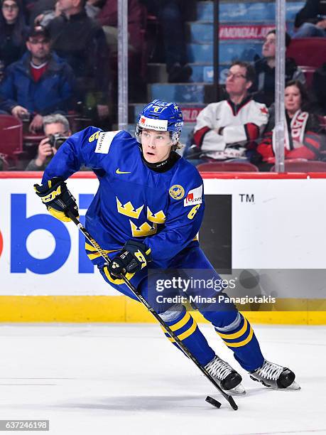 Kristoffer Gunnarsson of Team Sweden skates the puck during the 2017 IIHF World Junior Championship preliminary round game against Team Finland at...