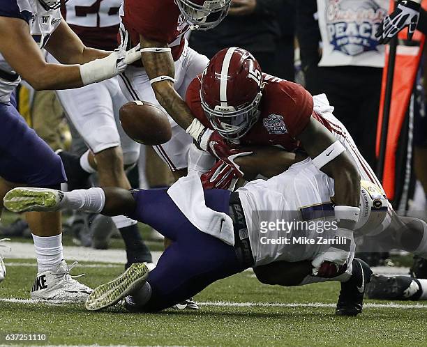 Defensive back Ronnie Harrison of the Alabama Crimson Tide forces a fumble by wide receiver John Ross of the Washington Huskies during the first...