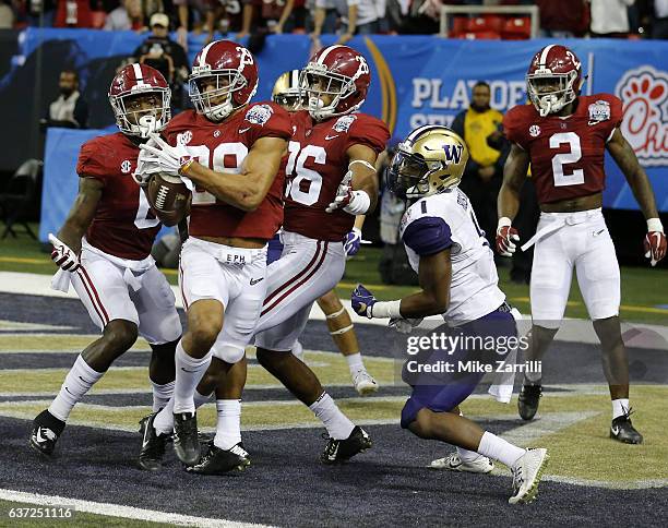 Defensive back Minkah Fitzpatrick of the Alabama Crimson Tide intercepts a pass in the fourth quarter in the 2016 CFP semifinal at the Peach Bowl at...