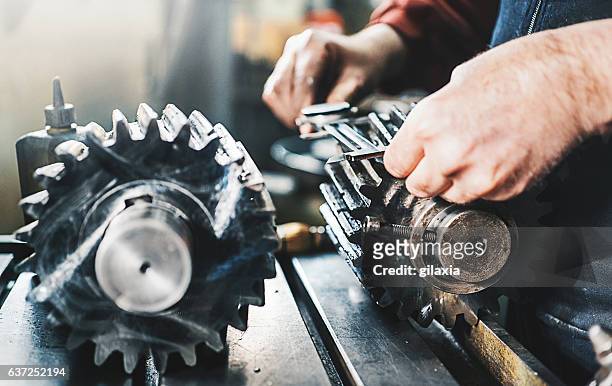 metal workshop. - engineer gearwheel factory stockfoto's en -beelden
