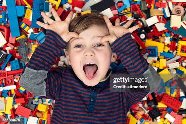 playful boy between plastic blocks - toy building blocks stock pictures, royalty-free photos & images