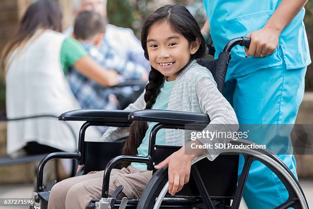 cheerful young asian girl in wheelchair - expo 2017 stock pictures, royalty-free photos & images