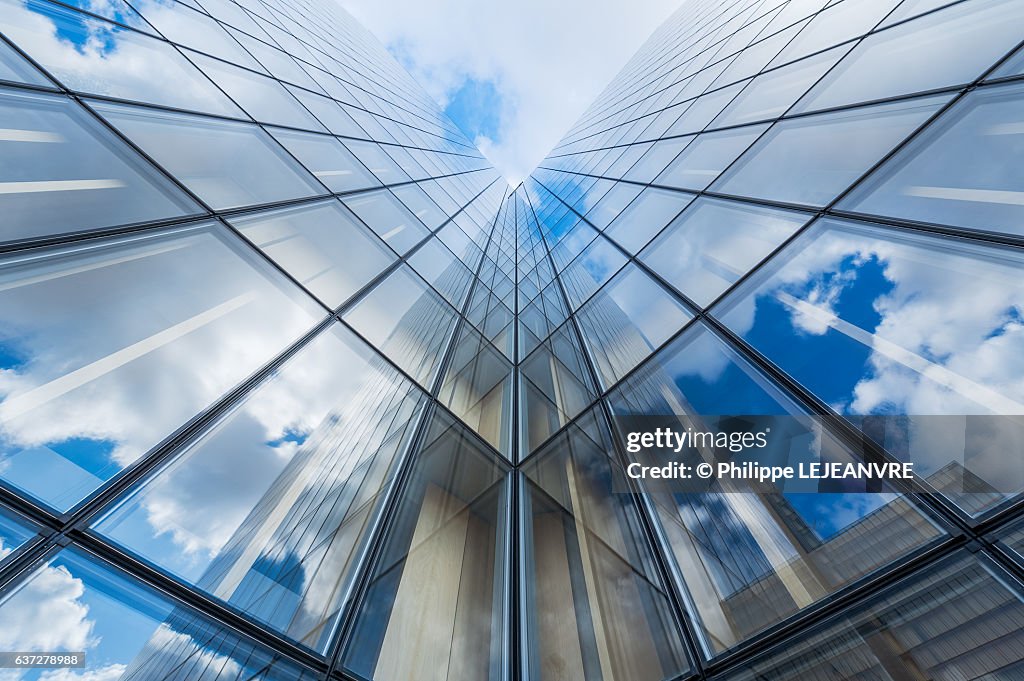 Blue sky and clouds reflections on a glass building