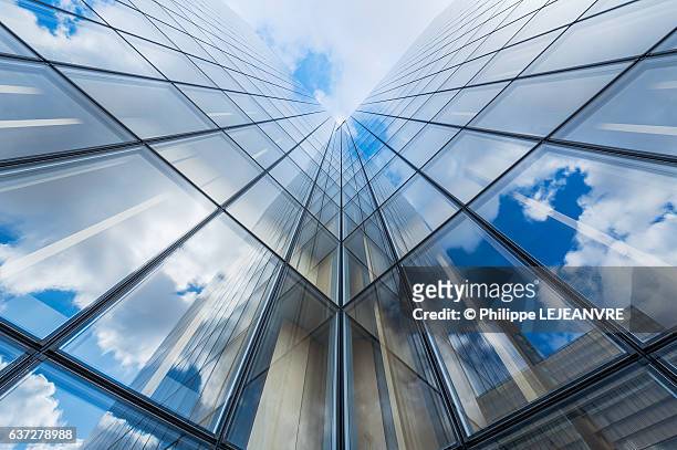 blue sky and clouds reflections on a glass building - symmetry stock pictures, royalty-free photos & images