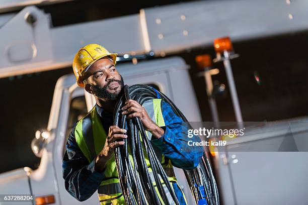 african american man with cherry picker truck - cable stock pictures, royalty-free photos & images