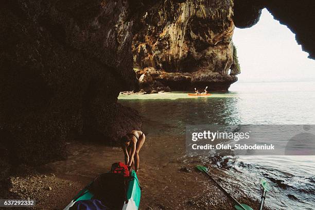 Woman pulling kayak  into the water