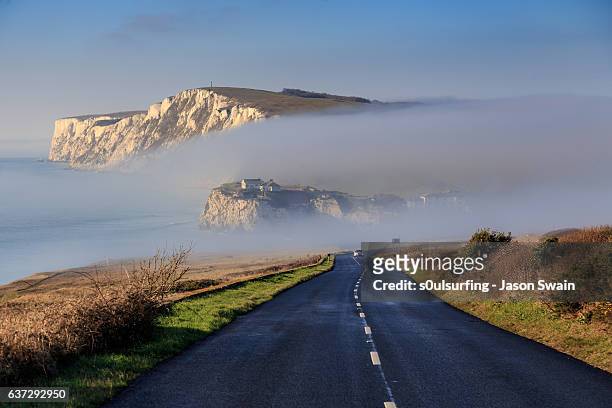 winter fog at freshwater bay on an otherwise sunny day - isle of wight stock pictures, royalty-free photos & images