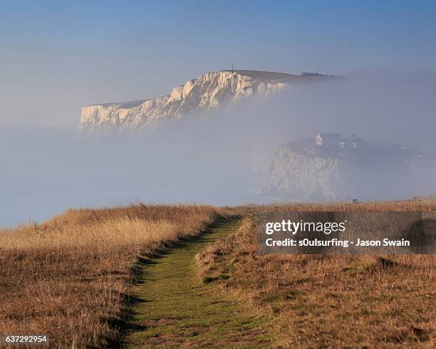 winter fog at freshwater bay on an otherwise sunny day - isle of wight winter stock pictures, royalty-free photos & images