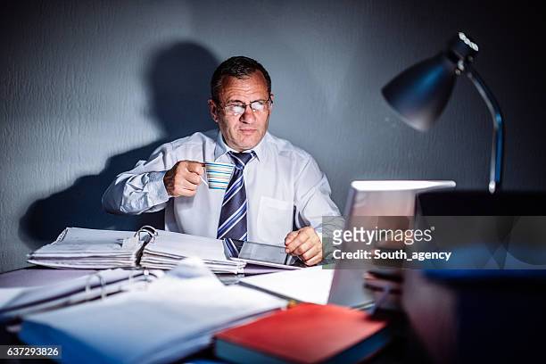 director working late - lonely businessman alone late at work stock pictures, royalty-free photos & images