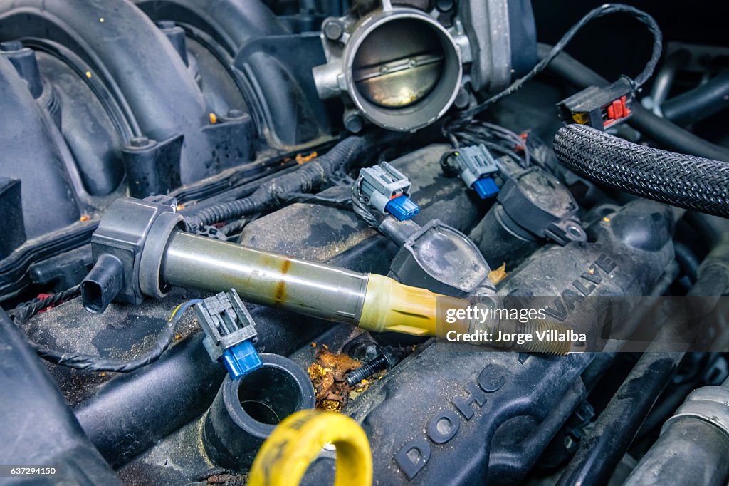 Car engine coils on a dirty engine
