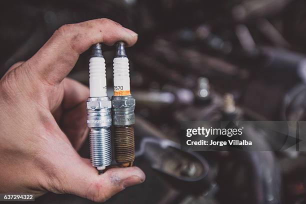 holding old and new car spark plugs on engine - rusty old car stock pictures, royalty-free photos & images