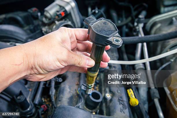 car engine coils on a dirty engine - ontsteking stockfoto's en -beelden