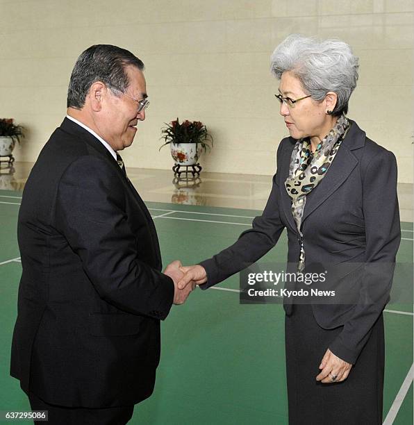 China - Japanese lawmaker Takeshi Noda , head of the ruling Liberal Democratic Party's panel on Asian-African issues, shakes hands with Fu Ying,...