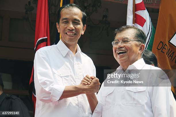 Indonesia - Jakarta Gov. Joko Widodo and former Indonesian Vice President Jusuf Kalla shake hands in Jakarta on May 19, 2014. The front-runner in...