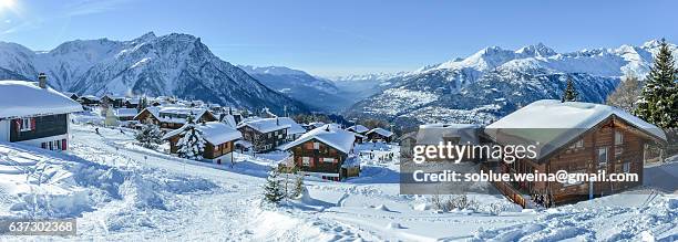 cabin retreat - brief cabins village in snow on the swiss alps with valais alps mountain range view - alpine lodge stock-fotos und bilder